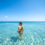 Woman in crystal-clear waters in Sardinia